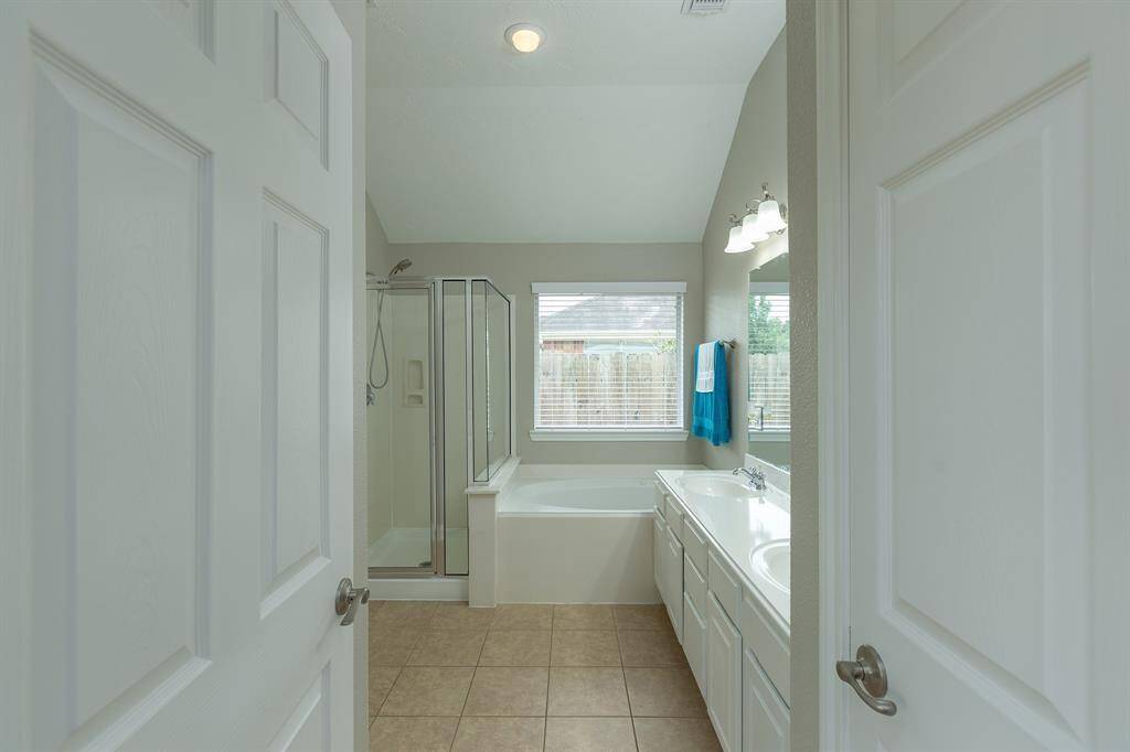 Relaxing master bath with double sinks, and separate shower and tub