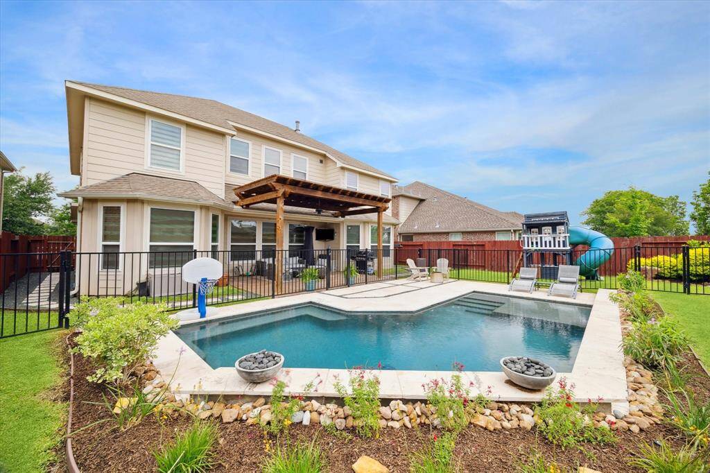 Enjoy your own backyard oasis featuring a heated pool, a spacious patio with a pergola, and plenty of room to relax or entertain.