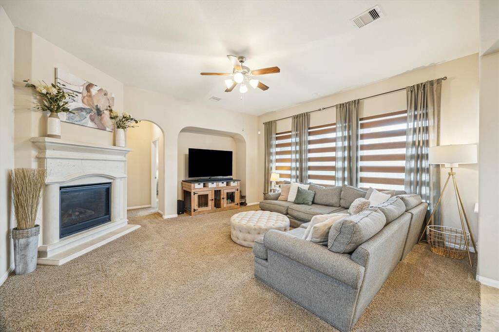 Spacious family room featuring a beautiful cast stone gas fireplace, perfect for cozy gatherings.