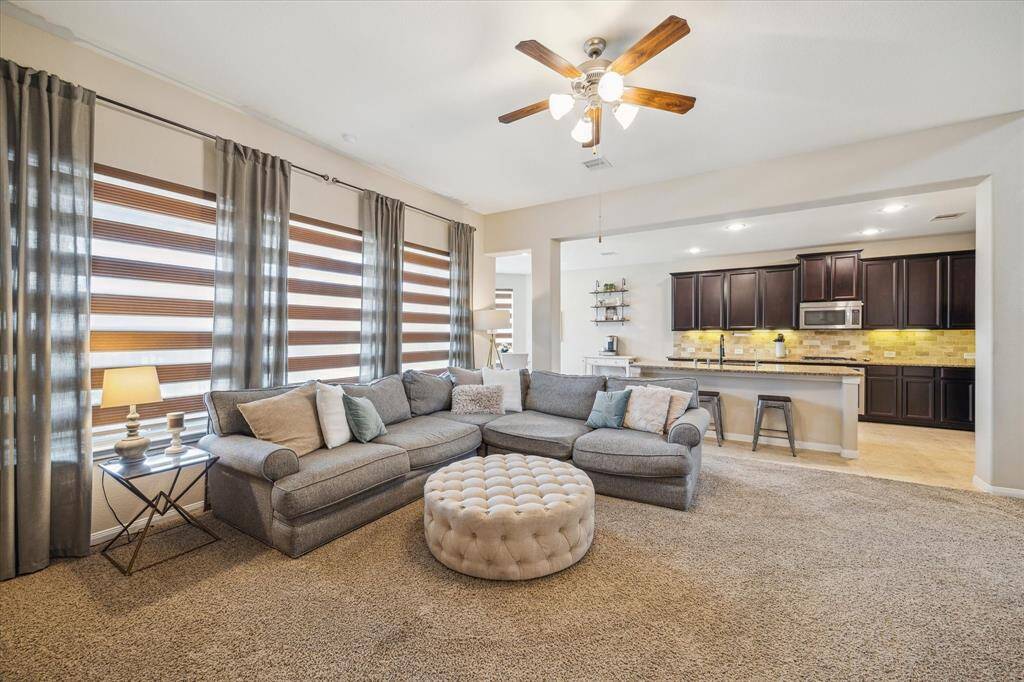 Large windows in the family room flood the space with natural light, creating a bright and inviting atmosphere.