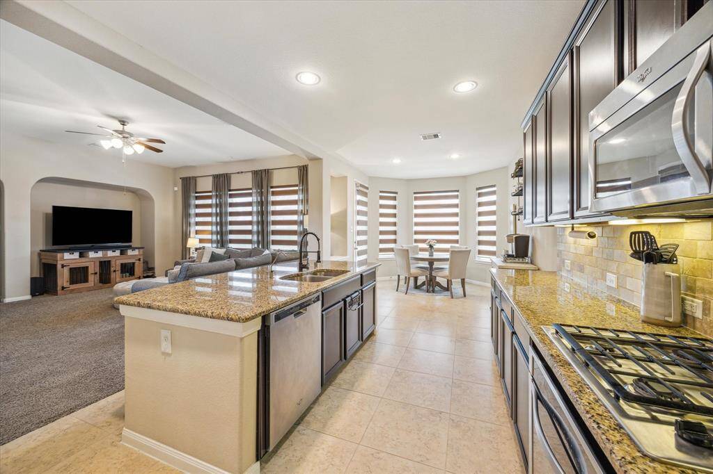 Open-concept kitchen overlooking the living room, perfect for seamless entertaining and family gatherings.