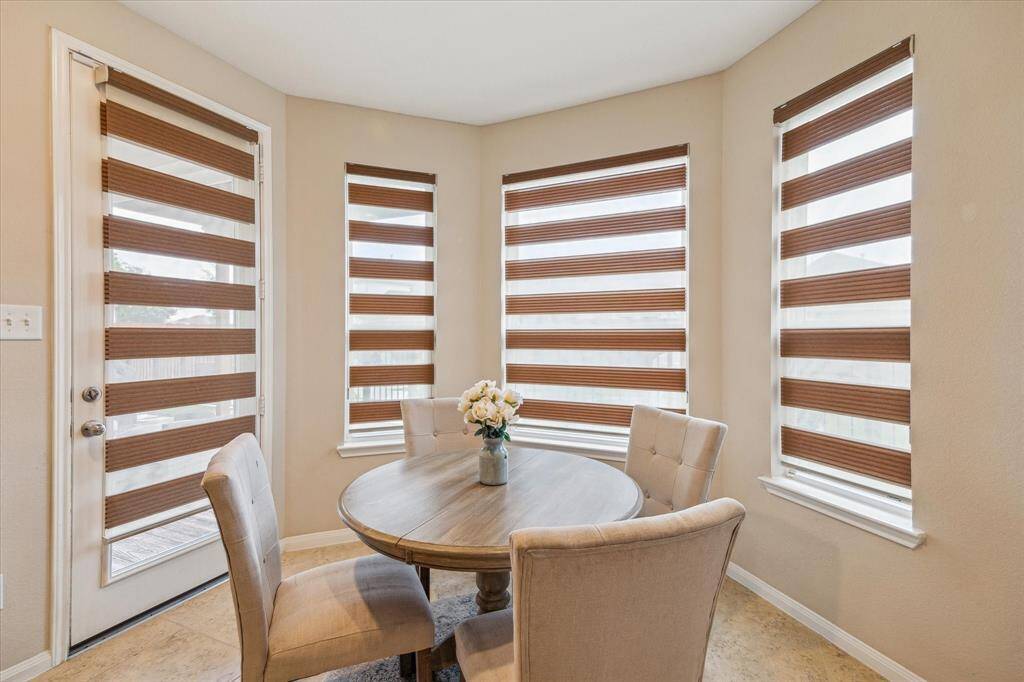 Bright breakfast area with windows that provide scenic views of the backyard, creating a serene spot to enjoy your morning.