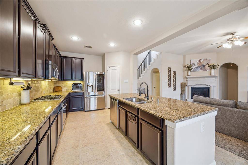 Equipped with stainless steel appliances, ample cabinet storage, and a convenient pantry for all your culinary needs.