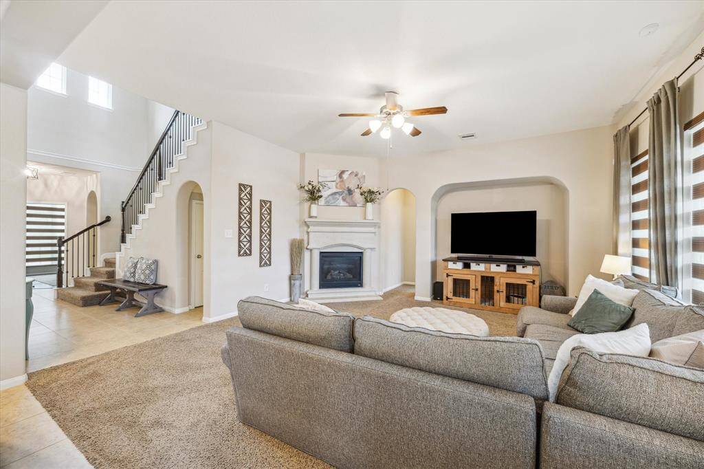 Spacious family room seamlessly flows into the primary suite, offering a private retreat for relaxation.