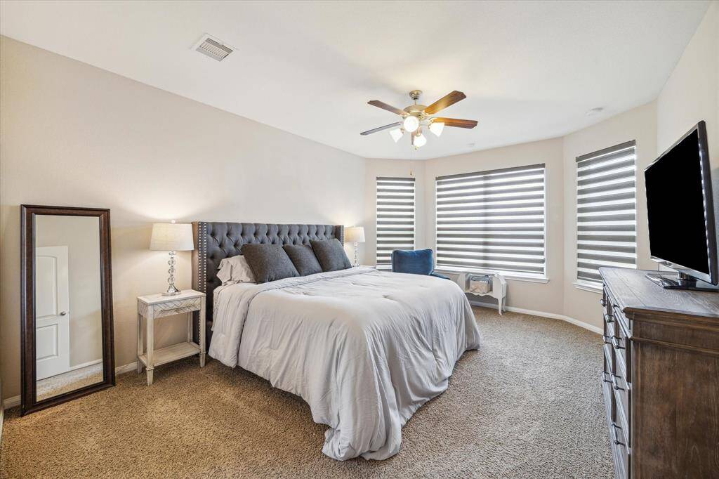 Spacious primary suite featuring large bay windows, filling the room with natural light and creating a peaceful retreat.