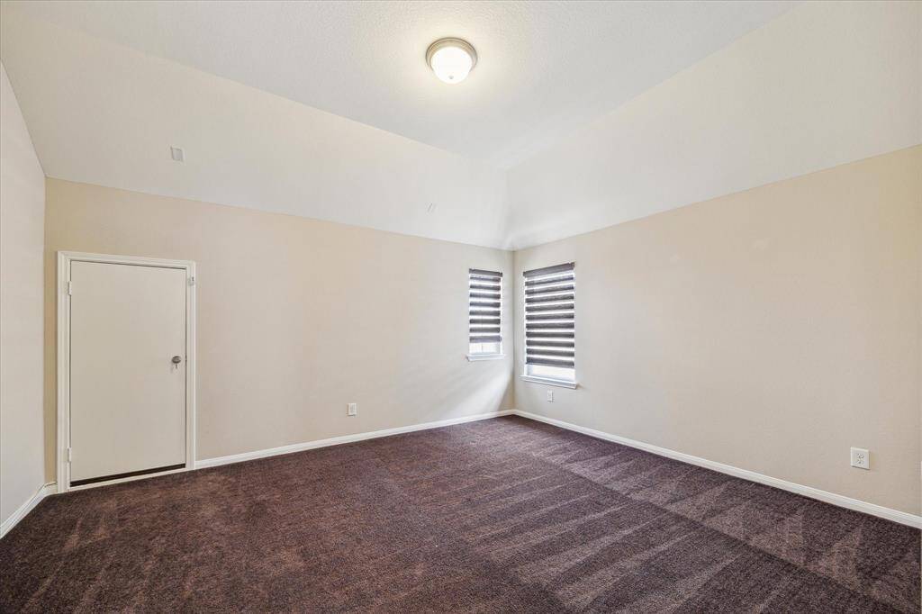 Spacious media room with convenient access to attic storage space.