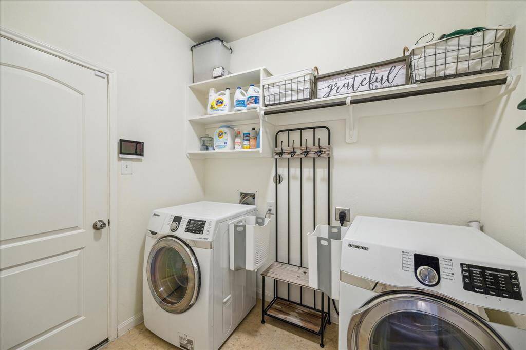 Convenient first-floor utility room with direct access to the garage, making chores and organization a breeze.