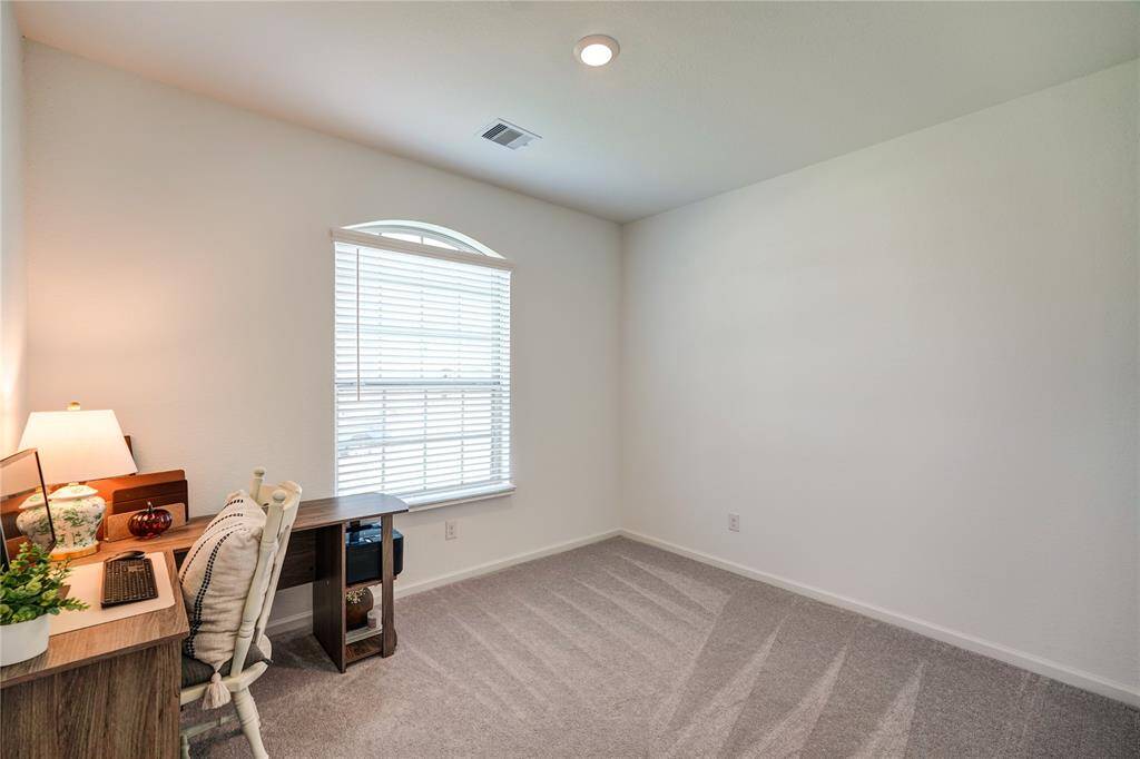 Secondary Bedroom, currently being used as an office. Views of the front yard.