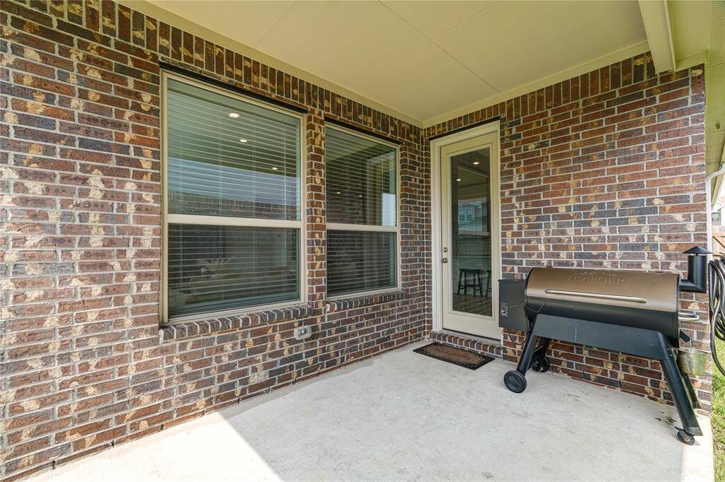 Covered back patio. The home features brick all around!!