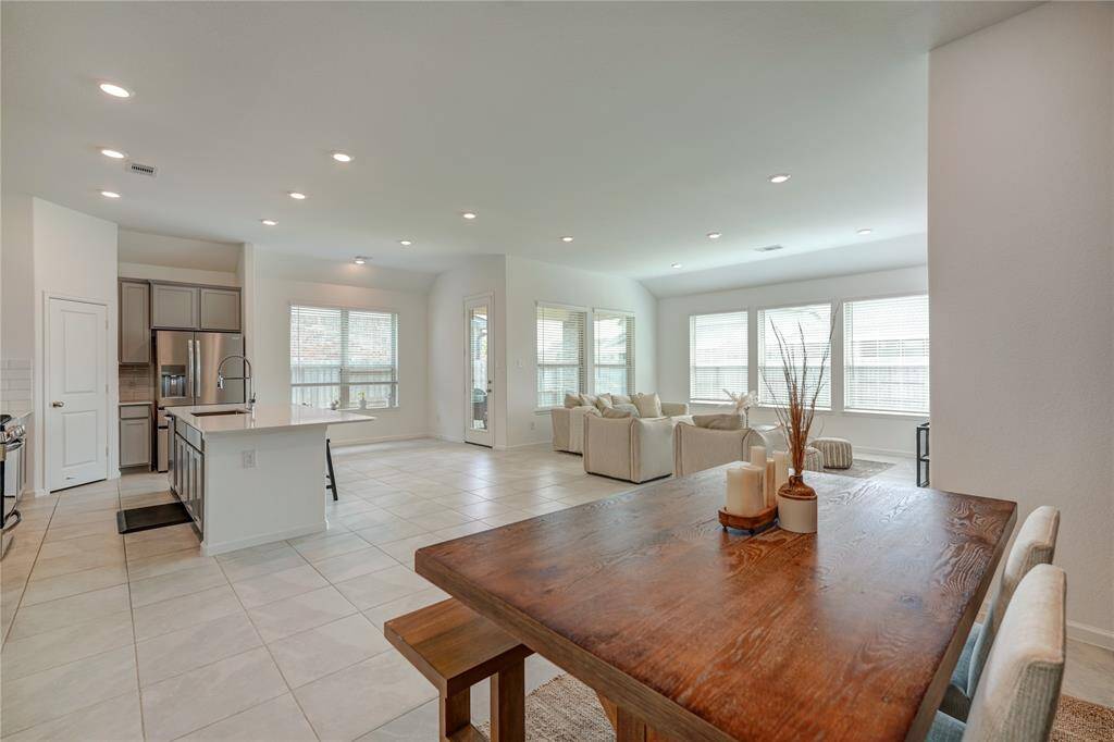 Breath-taking views from every angle! The oversized travertine tile complements the space with its neutral color. The formal dining room looks into the kitchen and living room. This space can also be converted into a study if you desire.