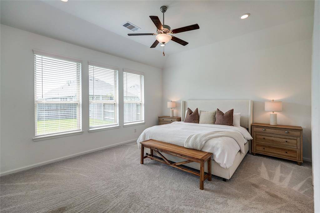 Plenty of natural light in your primary bedroom with the windows overlooking the backyard. This room also features an elevated ceiling, recessed lighing, ceiling fan and space for a sitting area if you desire.