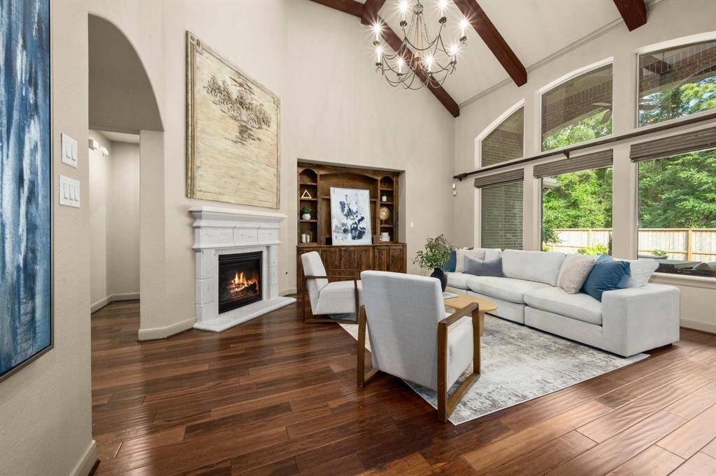 Living room with vaulted ceilings, lots of natural light & open to kitchen and breakfast room