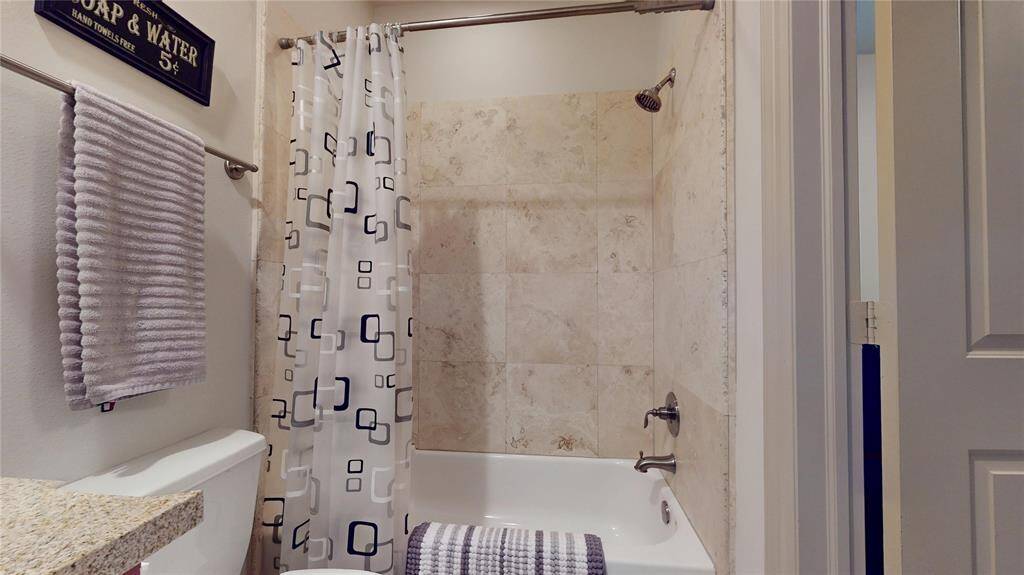 Another view of the first floor bathroom and its travertine shower stall...