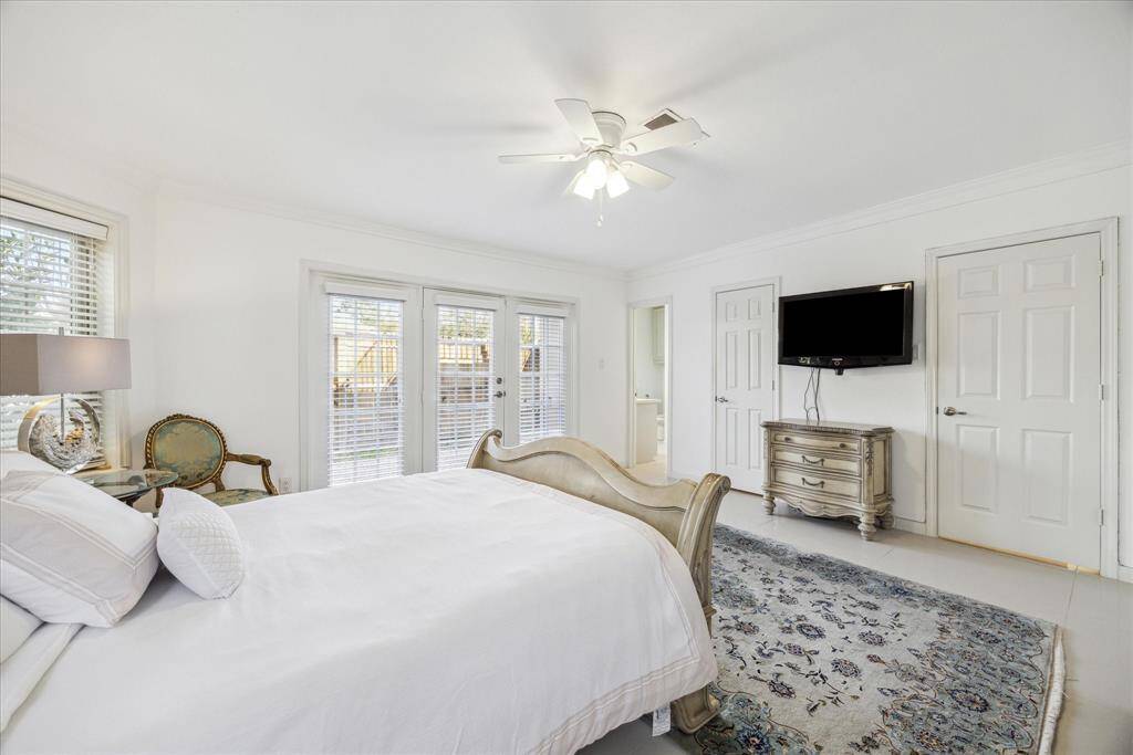 Primary bedroom has tile flooring and two walk-in closets.