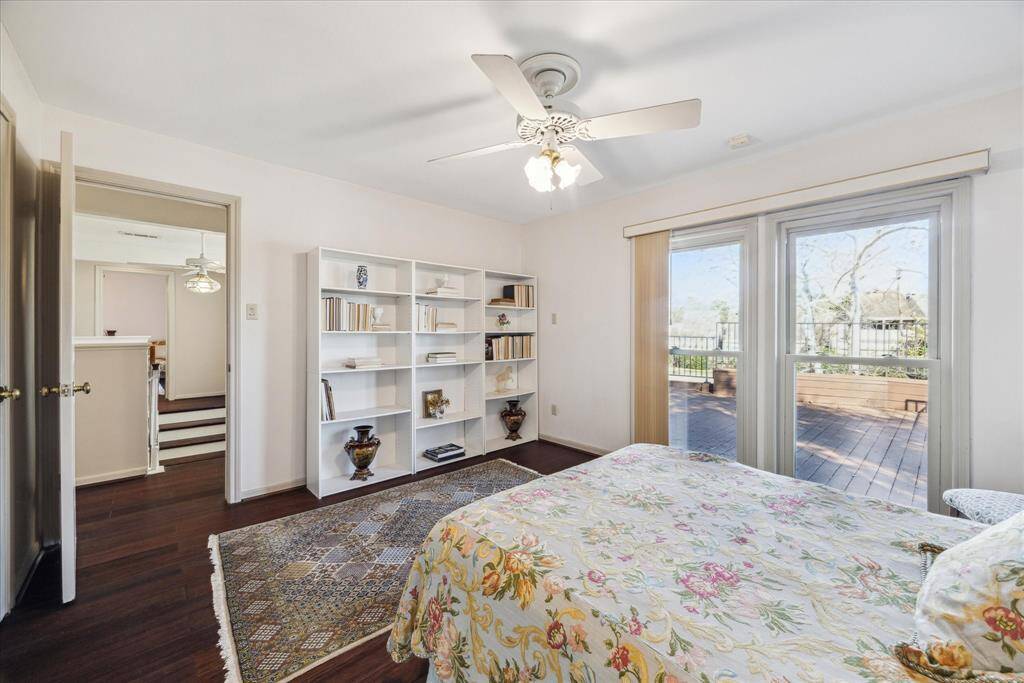 Second bedroom on the second floor with a door to the balcony and walk-in closet.
