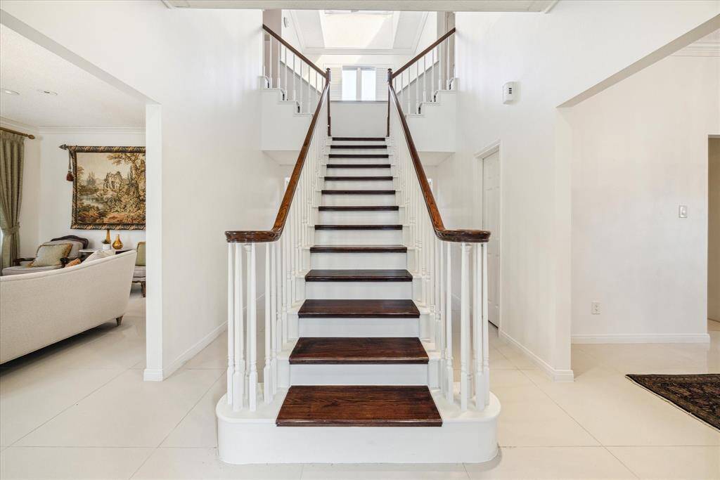 An entryway with unique architecture, featuring a formal dining room on the right and a living room on the left side.