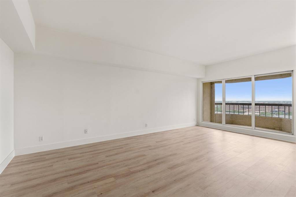 Spacious living room with private balcony access.