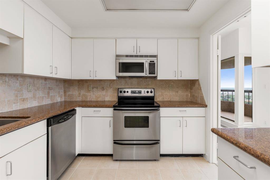 Kitchen with granite counters and stainless appliances.