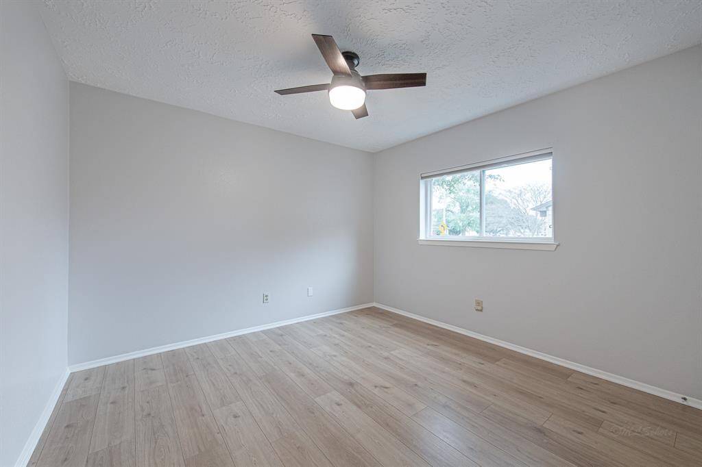 The 3rd bedroom features luxury vinyl plank flooring, double pane windows, sleek ceiling fan, and walk-in closet.