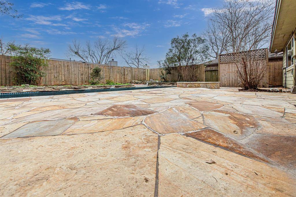 The flagstone patio is the perfect place to set up your dining set, patio loungers, and grill!