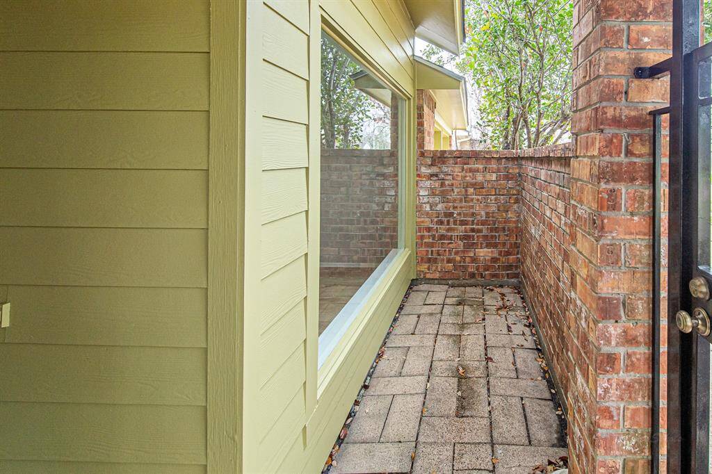 Step through the wrought iron gate to find a private courtyard where you can set up a patio set and some shade-loving plants.