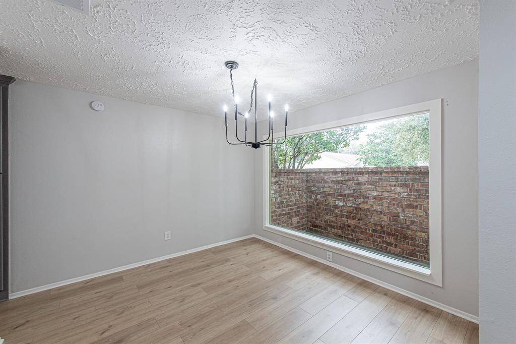 Walk through the front door to find a picture perfect interior! You are greeted with your dining room, complete with a wide picture window, soft decorator paint, 7" luxury vinyl plank floors, and a modern and elegant 6-arm iron chandelier.