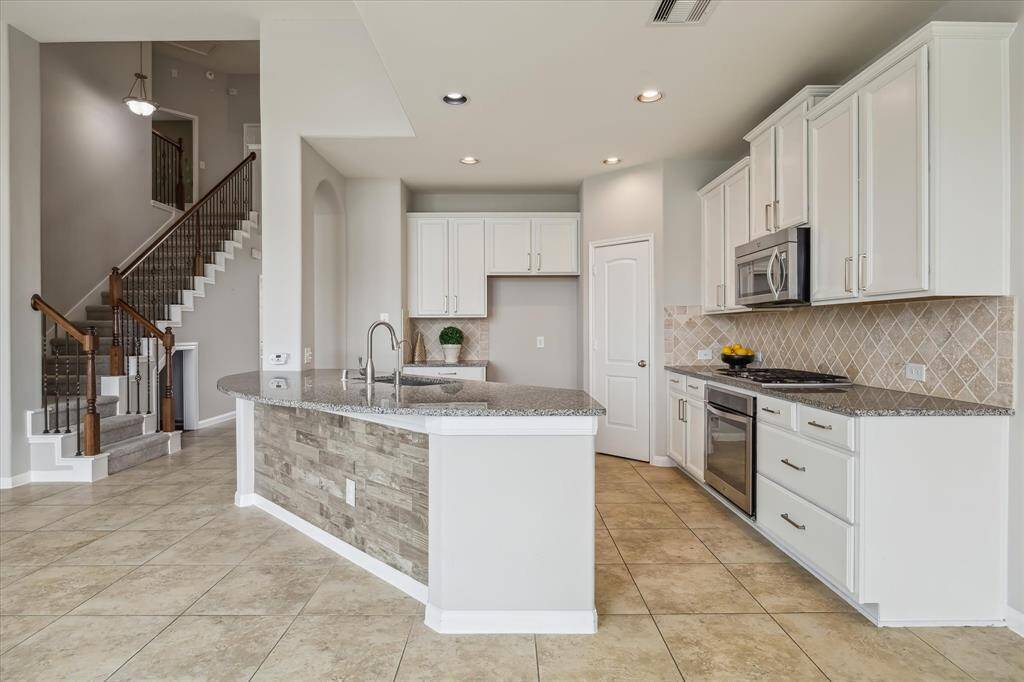 The kitchen is spacious and offers a countertop bar for additional seating
