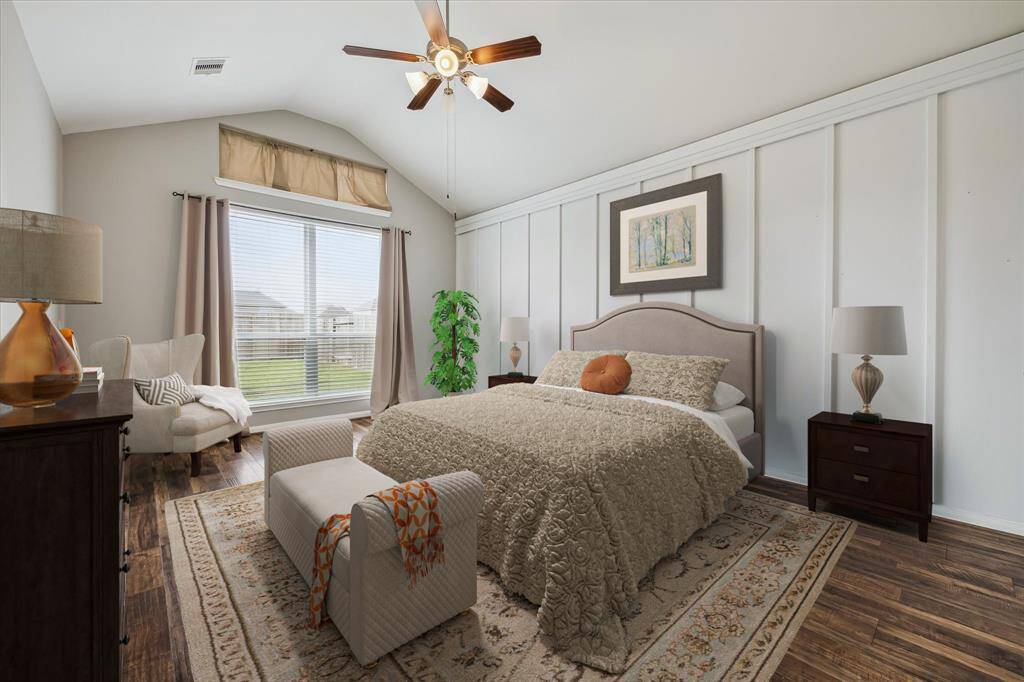 The primary bedroom offers a lovely accent wall with large windows, a vaulted ceiling, and is spacious enough for an additional seating area *virtually staged