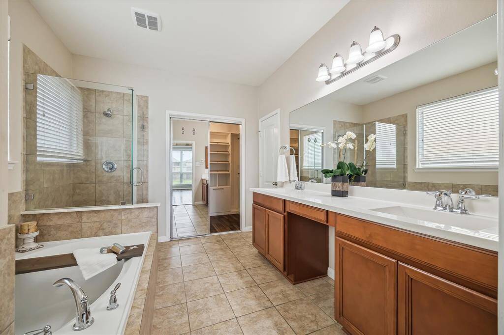 The Primary Bath offer a large double sink and vanity for plenty of storage and space to get ready in the morning
