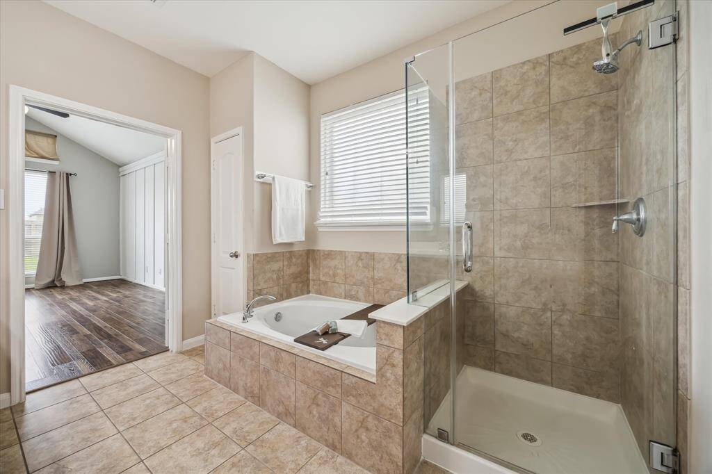 A frameless shower and oversized tub offer relaxing options to wash the day away.