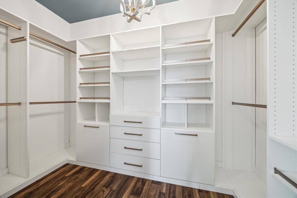 The lovely primary closet has custom-built ins to keep you organized and enjoying this space
