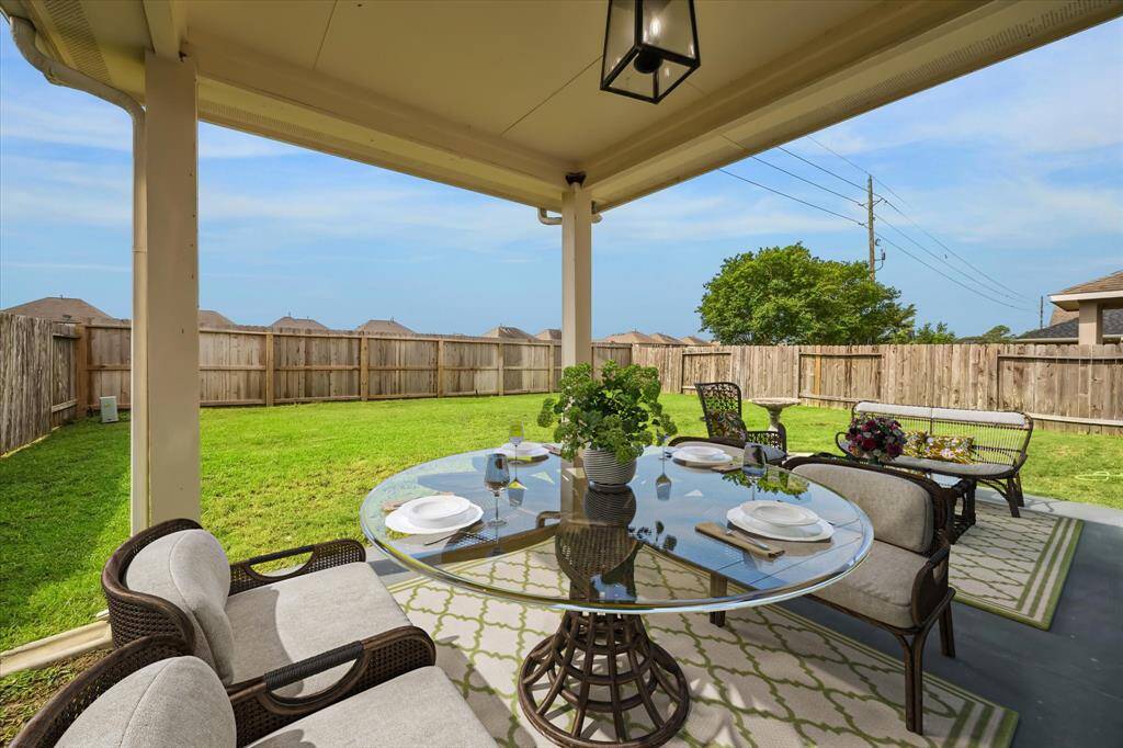 Escape to your private retreat with an expansive yard and covered porch with extended patio space for 2 outdoor areas *virtually staged
