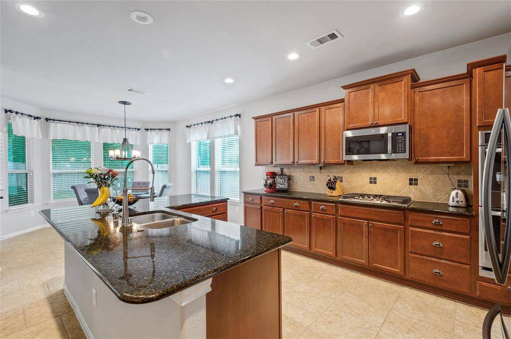 Spacious kitchen has and abundant of granite counter space, wonderful wood cabinets and stainless steel appliances to boot.