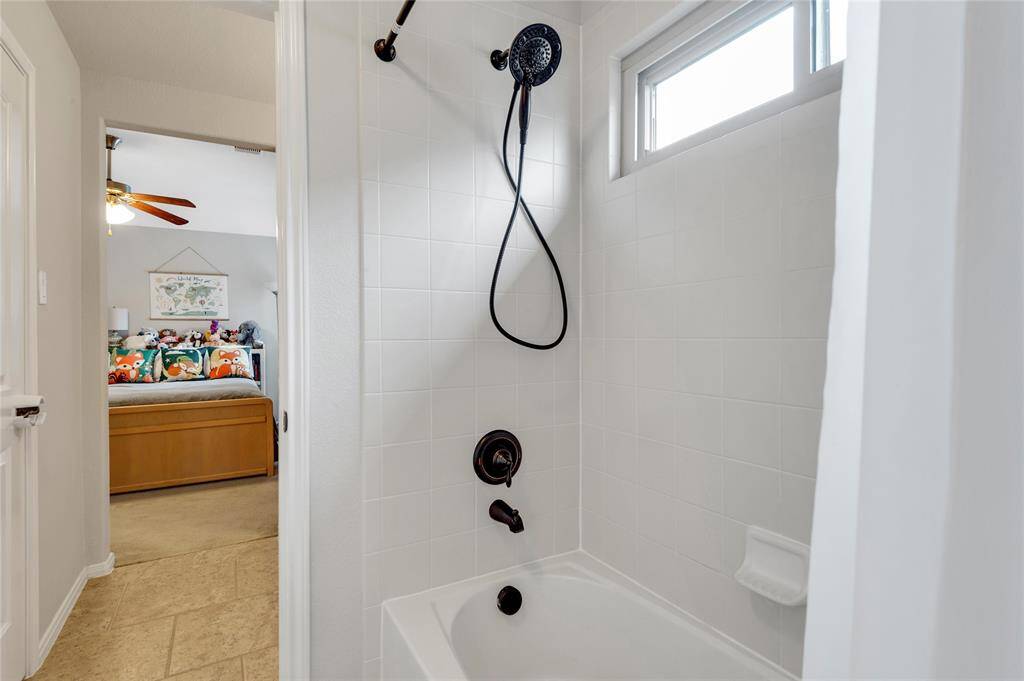 Oil rubbed bronze fixtures update this tub/shower combo in the hack-n-jill bath.
