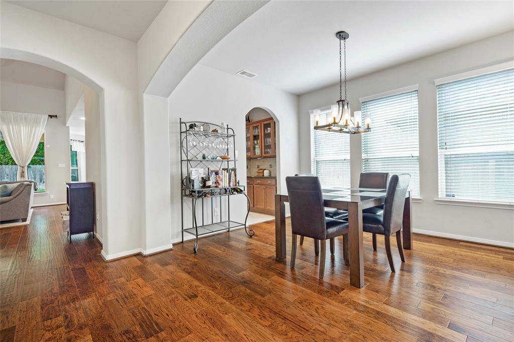 Wowza! This is the two story family room that overlooks the park like backyard and is open to the kitchen/dining areas.