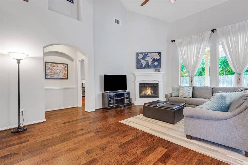 FABULOUS two story family room with a cozy fireplace, open wrought iron staircase and big enough space for your giant tv.