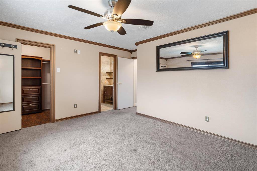 Primary bedroom with en suite bath and walk in closet with built ins
