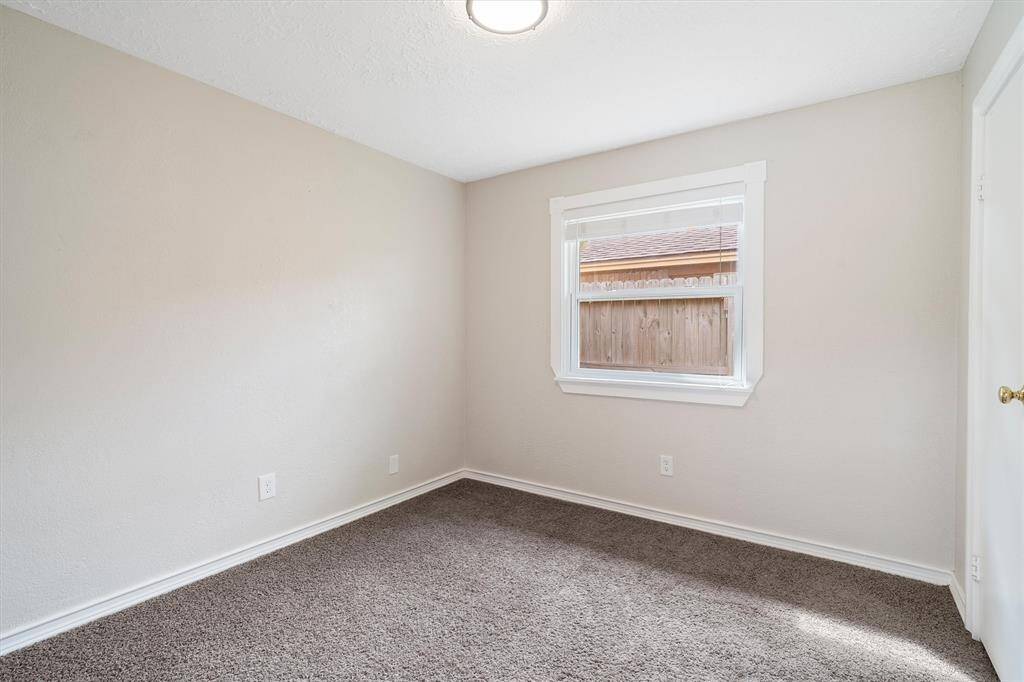 Third bedroom with window overlooking side yard