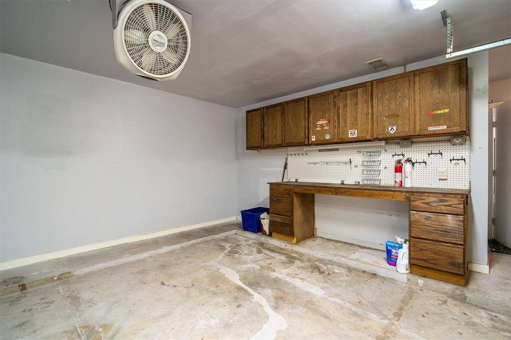 Garage with workbench and fan can stay!