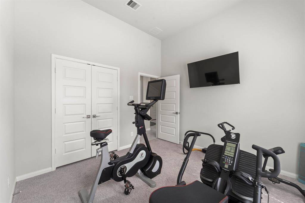 Secondary bedroom #2 is currently being used as a fitness room.  This bedroom is to the left of the entry.
