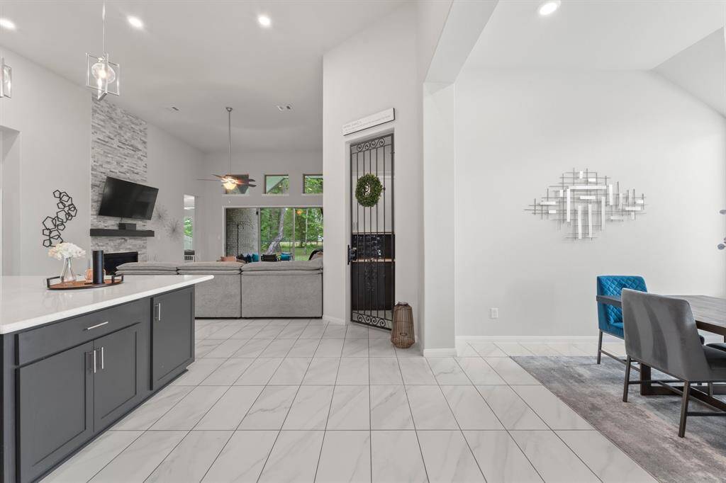 Down the entry hallway, it opens up into the kitchen / dining / family room areas. Straight ahead behind the iron gate is this home's own wine grotto.