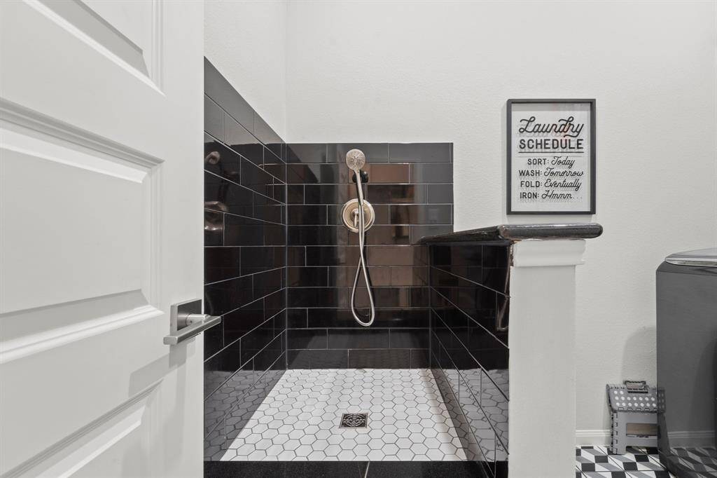 Tucked back behind the kitchen across from the walk-in pantry is the laundry room fully equipped with a dog washing station.