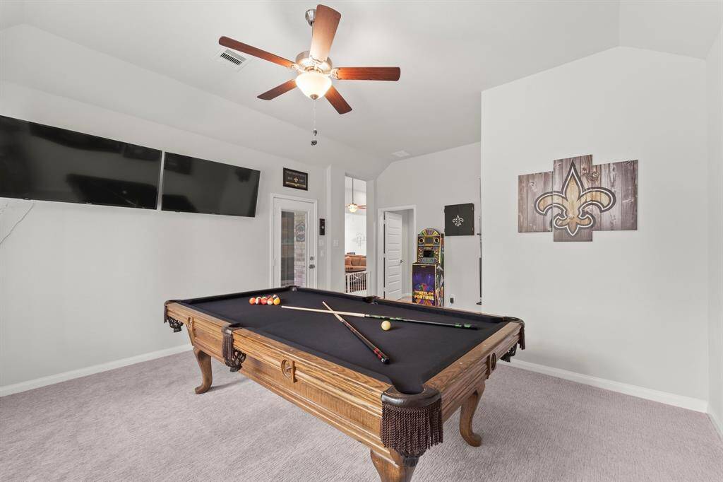 So many extra rooms in this house that you can use for your own hobbies/ interests.  The back room off of the family room is being used as a game room with the pool table, video game and tvs.  There is a half bath that is connected to this back room as well.