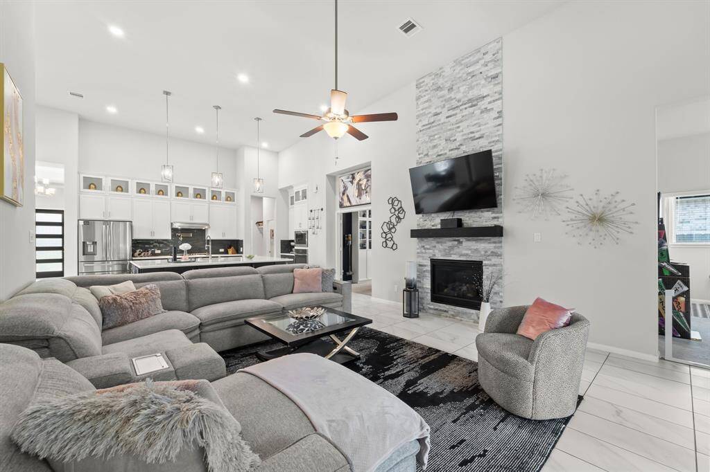 The heart of the home is this beautiful family room with a gas fireplace surrounded from floor to ceiling with stone.