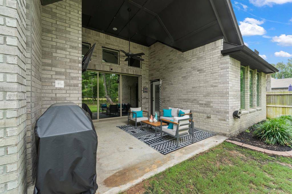 Notice the large wall of windows from the family room and high vaulted ceilings on the back patio!  The back door is from the game room.