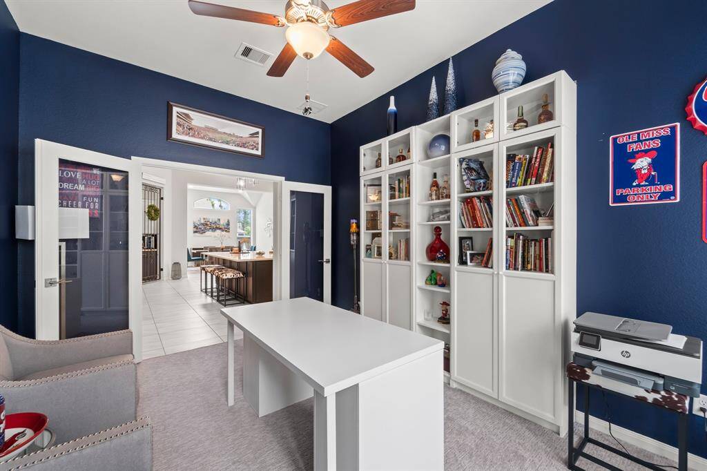 This private home office/study sits just off of the main living space and has a great built in for books and more storage.