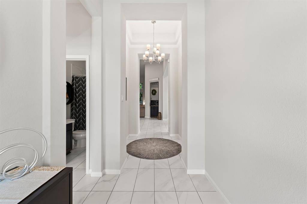 The formal entryway has high ceilings, crown molding, and leads you right into the main living spaces.