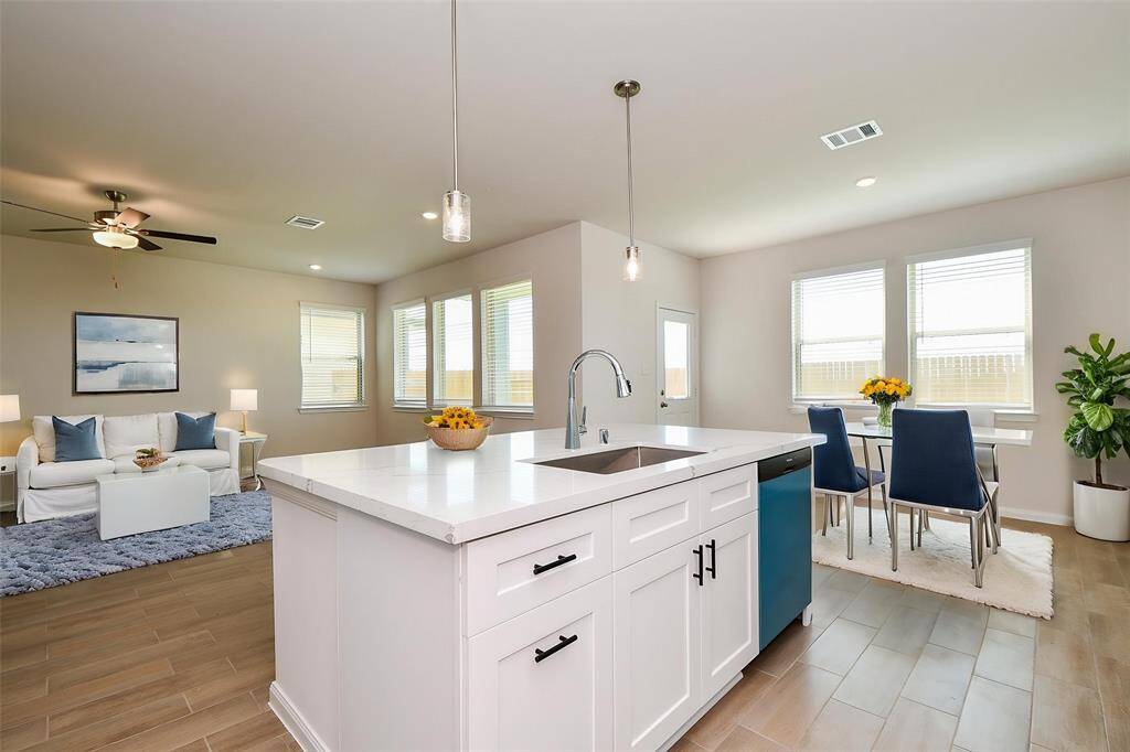 The spacious island with bar seating and the effortless flow of the floor plan in between rooms.
