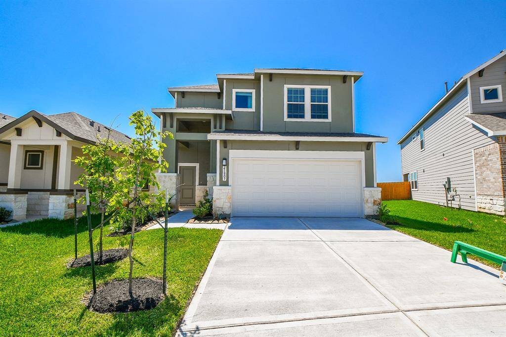 This home has an inviting curb appeal with its beautiful brick and green siding.