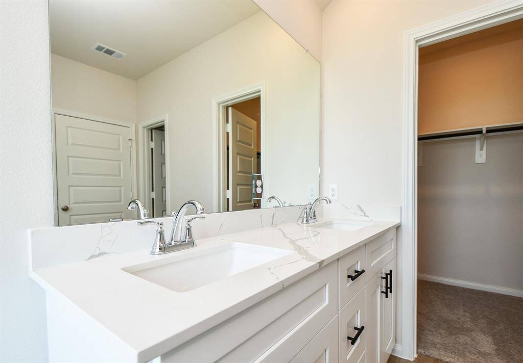 Gorgeous big vanity mirror with bright lights above it.